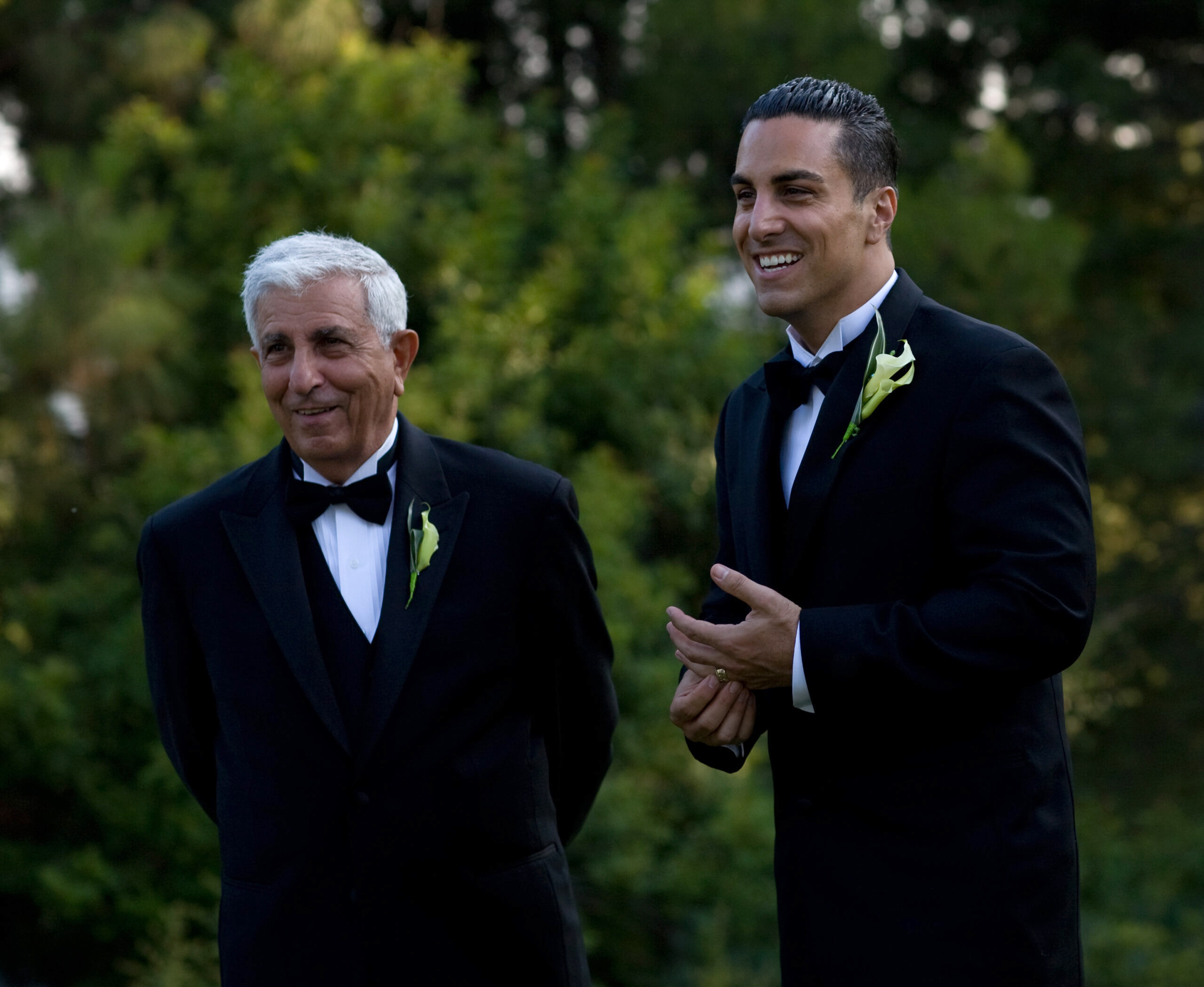 Joseph Gatto standing to the left of Mike Gatto, both wearing black tuxedos. They smile toward the same direction to the left.